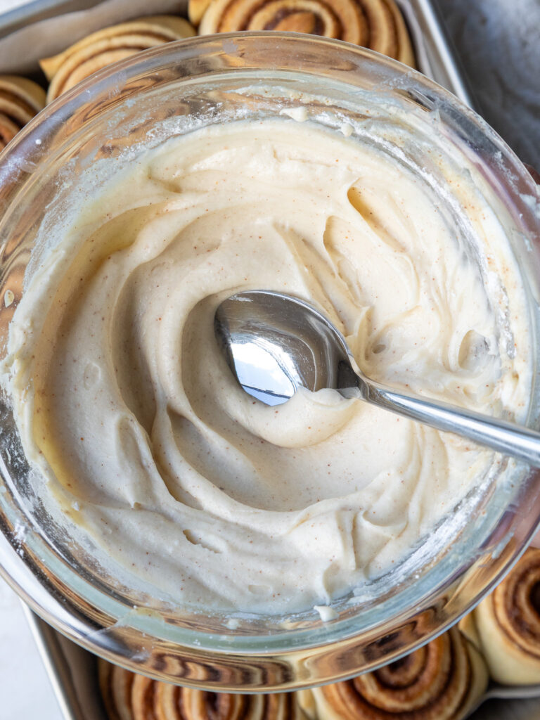 image of brown butter cream cheese icing that's been made to frost cinnamon rolls