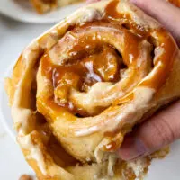 image of a caramel apple cinnamon roll that's been drizzled in homemade caramel