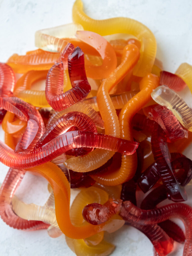 image of homemade gummy worms being held in a hand