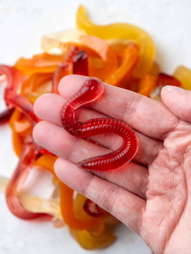 image of homemade gummy worms being held in a hand