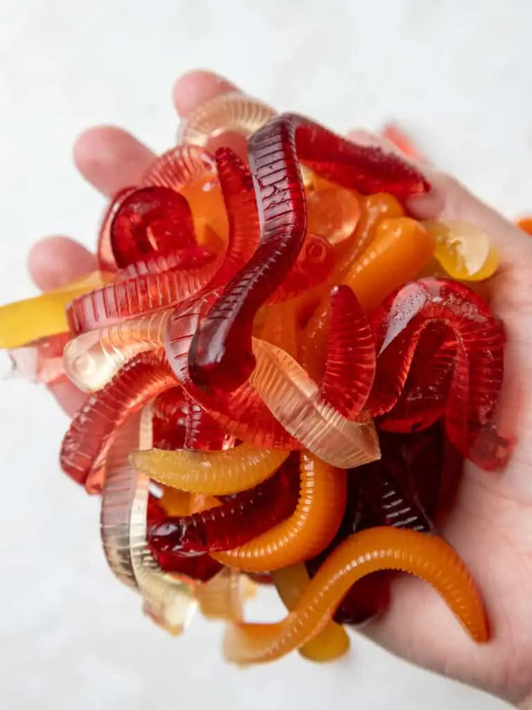 image of homemade gummy worms being held in a hand