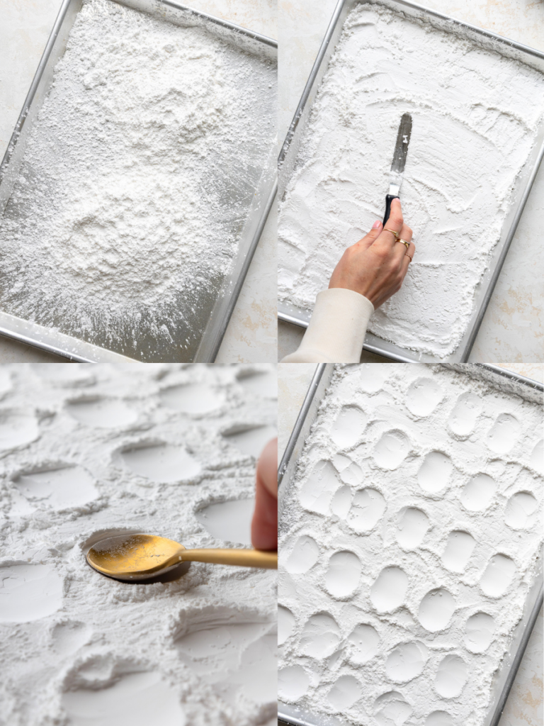 image of cornstarch being spread on a baking sheet to prep for frog marshmallows