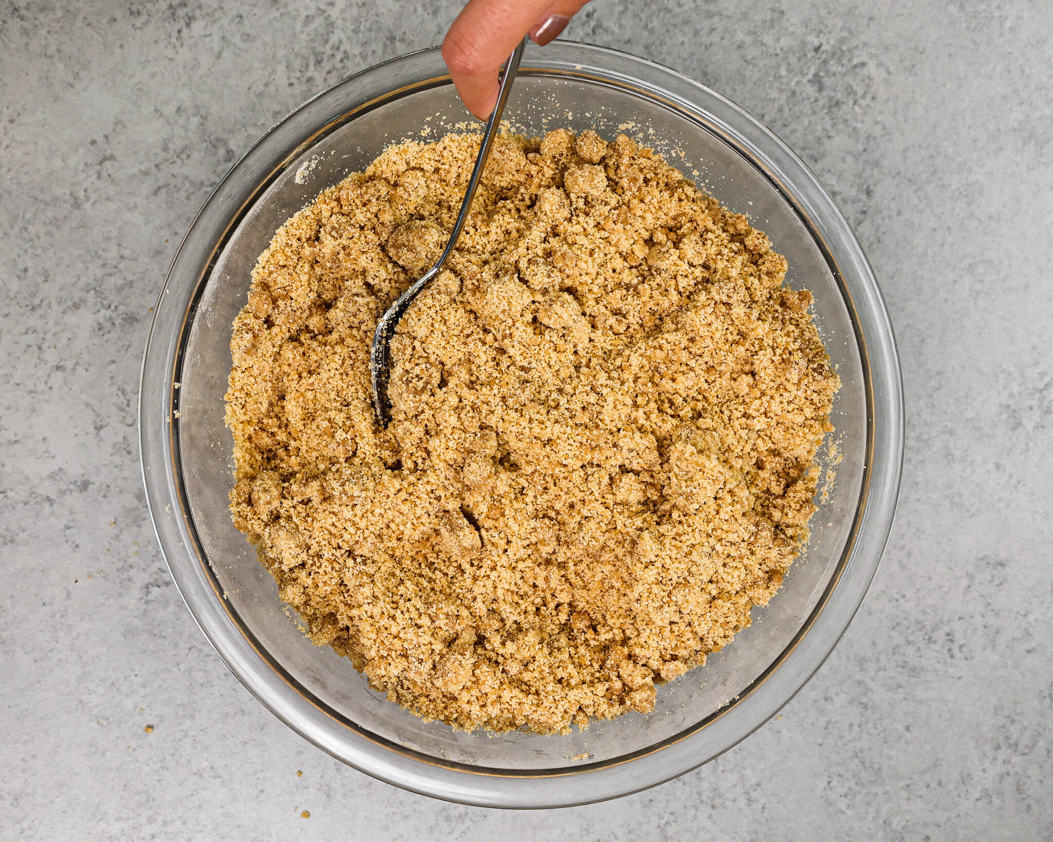 image of cinnamon streusel topping being made with a fork
