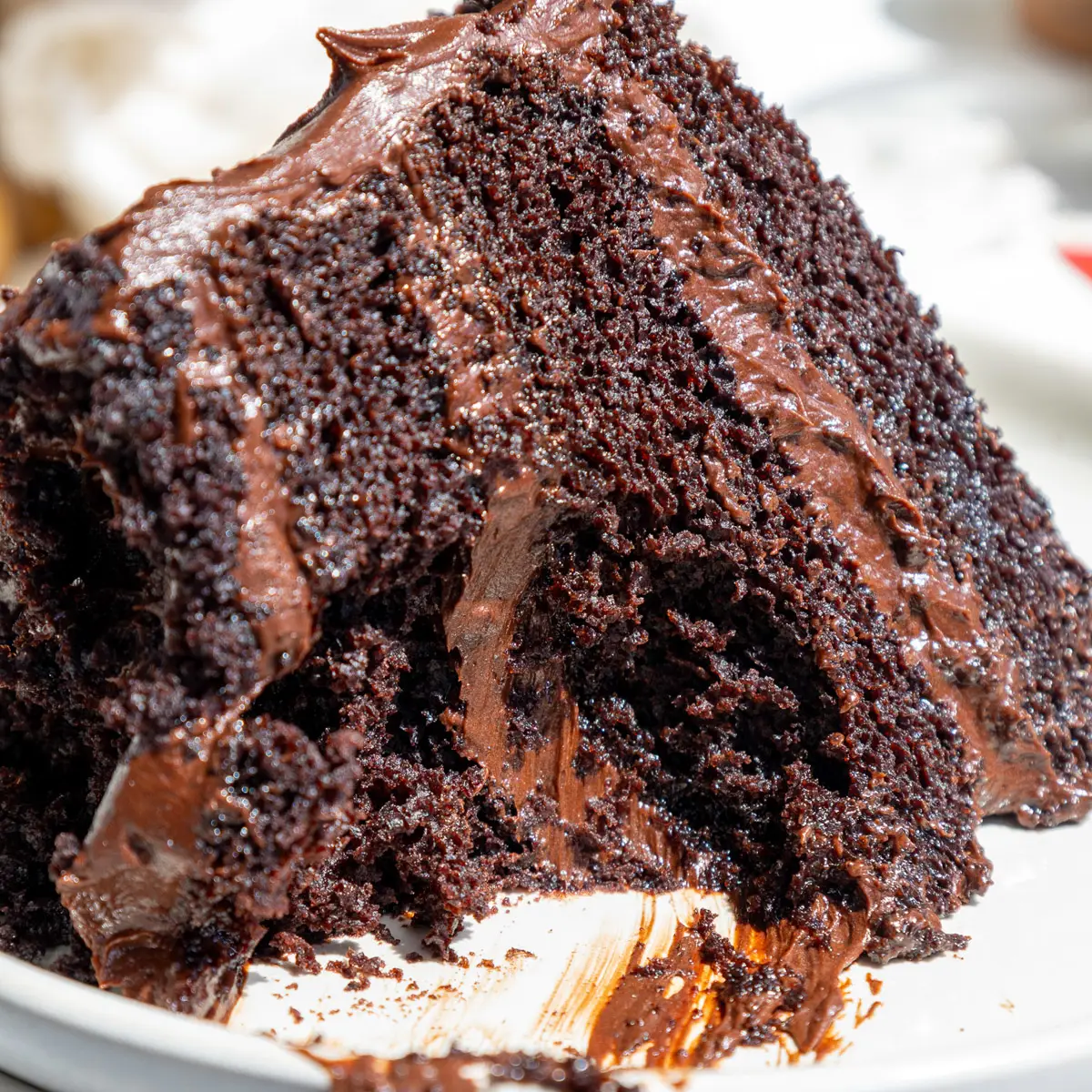 image of a slice of death by chocolate cake that's been cut into to show it's amazingly moist texture