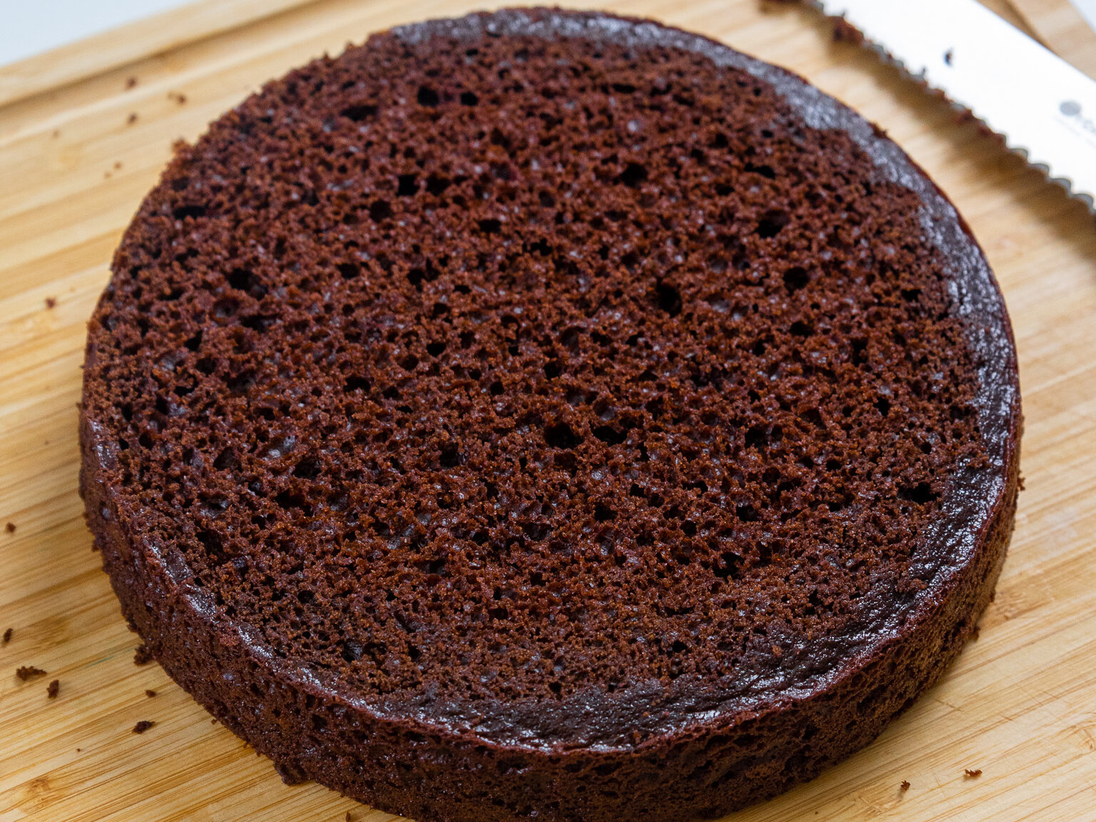 image of a moist chocolate cake layer that's been leveled with a serrated knife