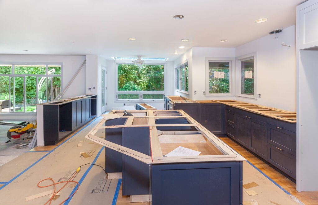 In the middle of a kitchen renovation installing brand new blue cabinets and an island