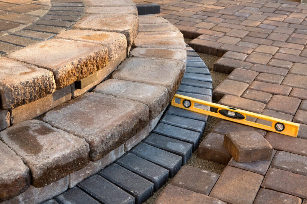 Measuring bricks to improve an outdoor walkway and stairs