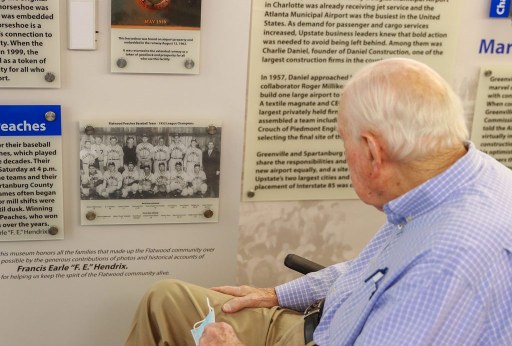 F.E. Hendrix reviews a picture of his baseball team the Flatwood Peaches on display at the GSP Airport Museum.