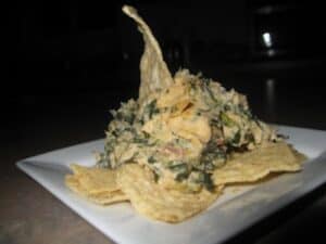 Image shows cheesy hot spinach dip.