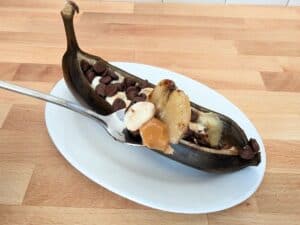Image shows spoonful of easy to make banana boat.