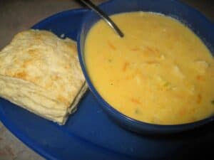 Image shows cheesy chicken soup in a bowl.