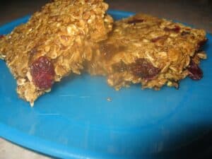 Image shows baked granola bars on a plate.