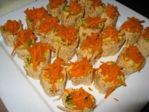 Image shows hummus "sushi" roll ups on a plate.
