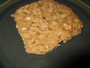 Image shows lacy cookie on a serving plate.