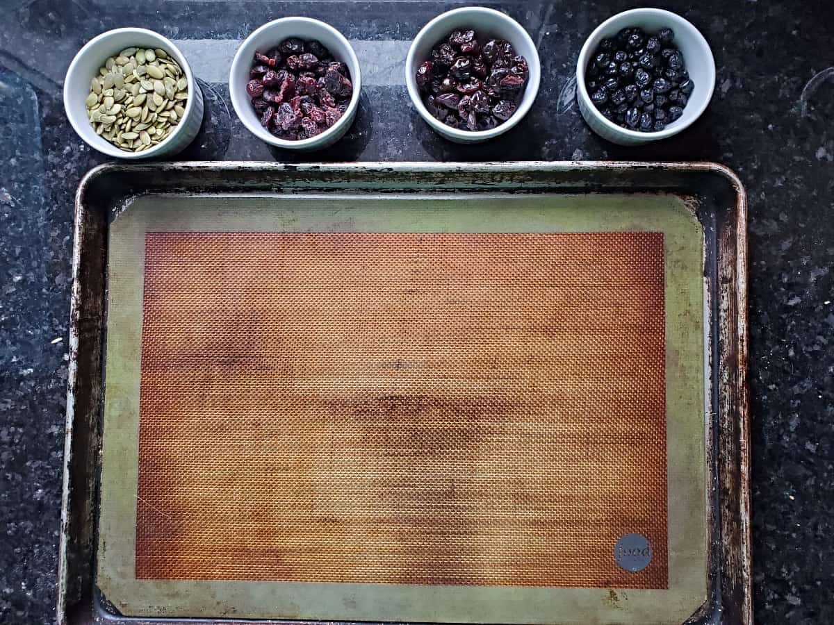 Overhead of a silpat on jelly roll pan with four ramekins above it.