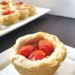Single cream cheese biscuit cup with tray in background