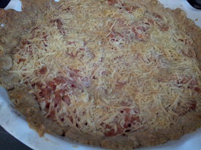 Whole tomato tart in a pie dish fresh from the oven.