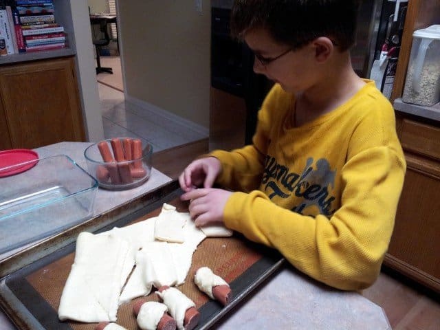 Mister Man preparing bagel dogs