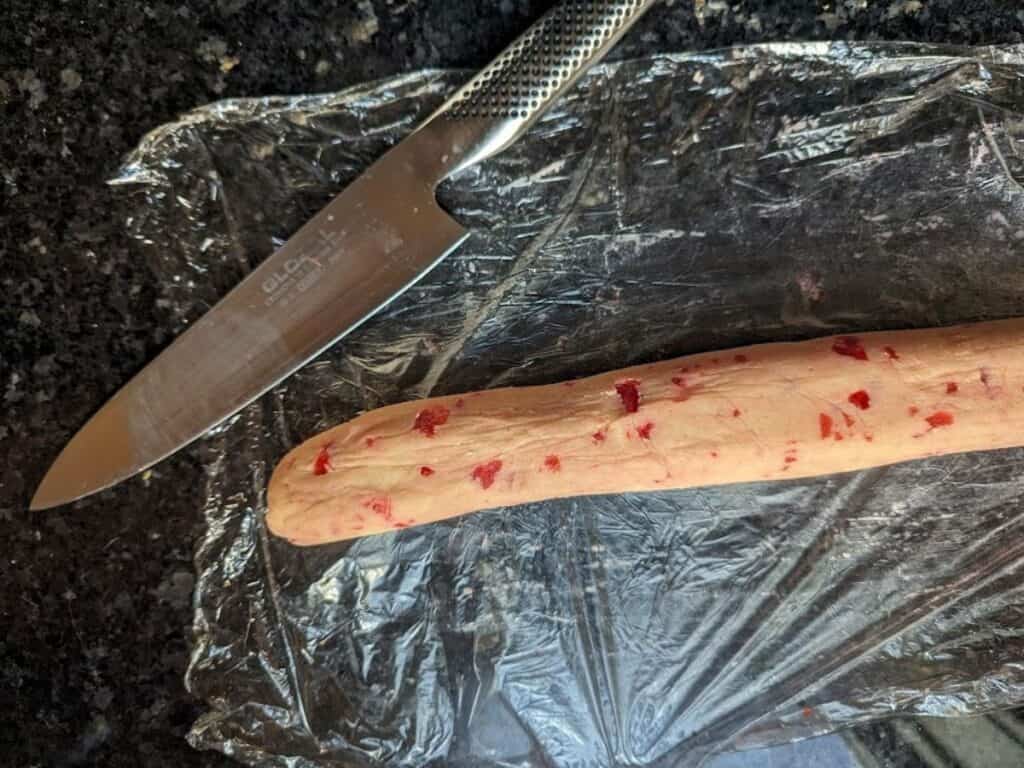 Image shows to be sliced cherry sugar cookies.
