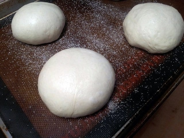Bread bowls sitting on a baking sheet