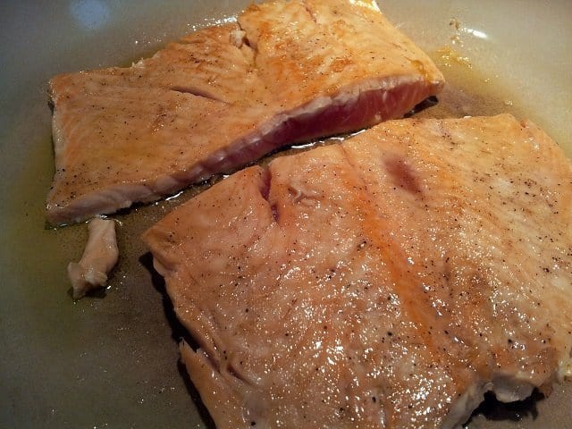 Cook salmon on stove before oven