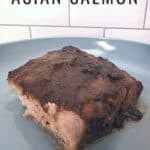Salmon fillet on a plate with text oven baked asian salmon.