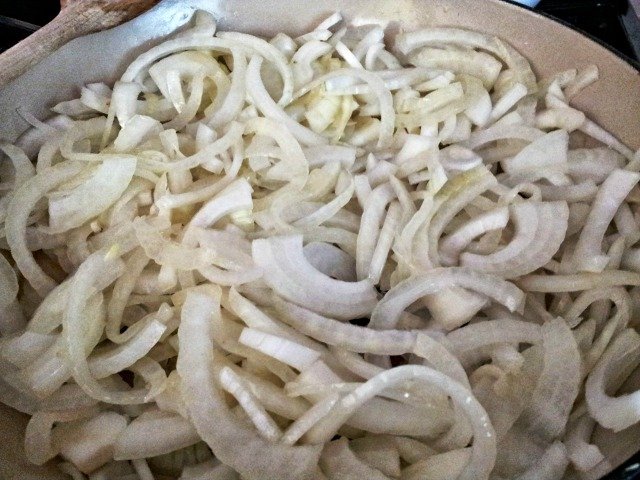 Sliced onions in the pan ready to cook