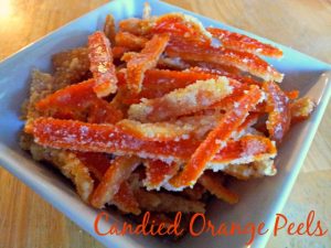 Candied orange peels are a fun way to use up all your favorite fruit. This vegan dessert is easy to make and tastes fantastic. Enjoy alone or dip your candied orange peels in chocolate! #candiedfruit #oranges #uniquedesserts #vegan