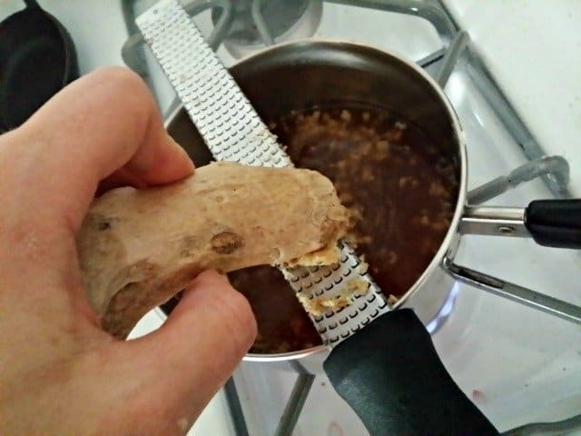 Grating fresh ginger into thai dipping sauce