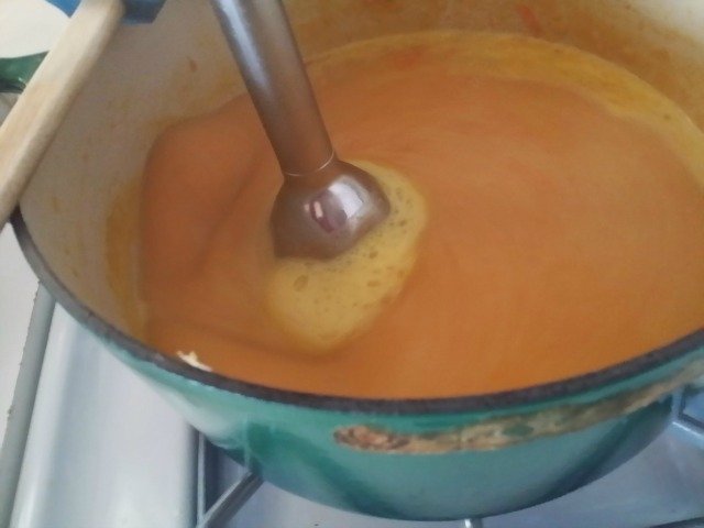 Immersion blender pureeing beer cheese soup