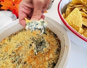 Scooping spinach artichoke dip