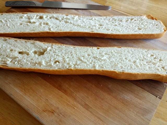 Bread sliced in half for garlic bread