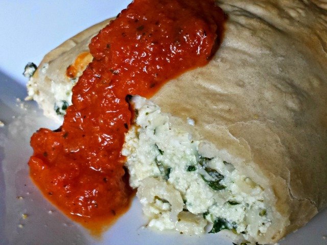Beautiful homemade calzone with tomato sauce garnish