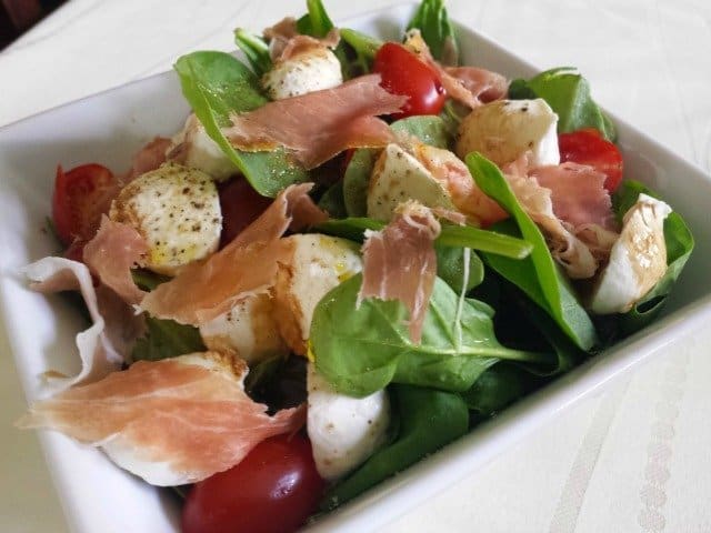 Single serving of spinach caprese salad