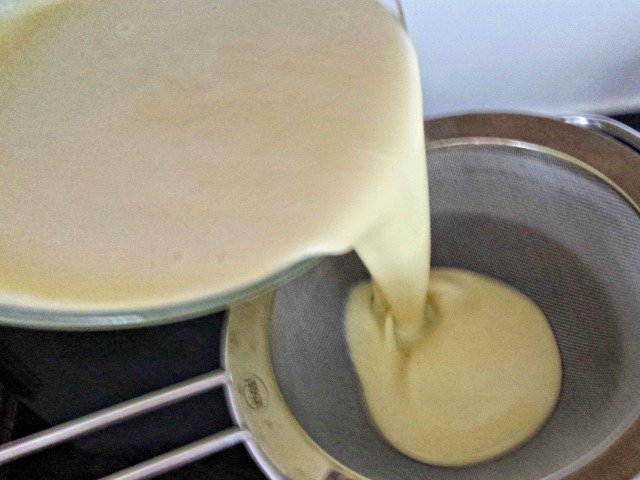 Strain your custard base just before freezing in your ice cream maker