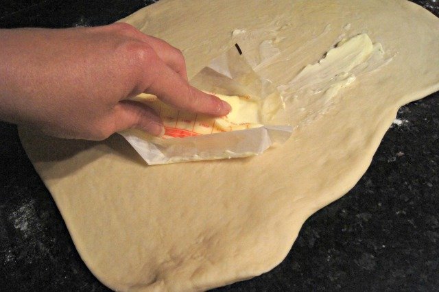 Add softened butter to cinnamon roll dough