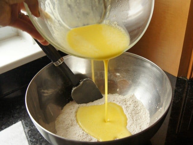 Pouring wet ingredients into dry ingredients