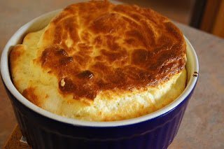 Cheese Souffle in an individual blue ramekin.