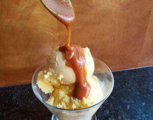 Drizzling caramel onto ice cream