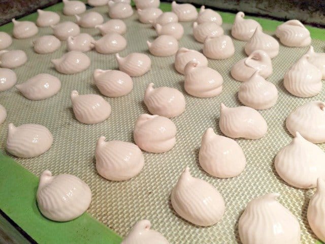 Tray of uncooked raspberry meringues