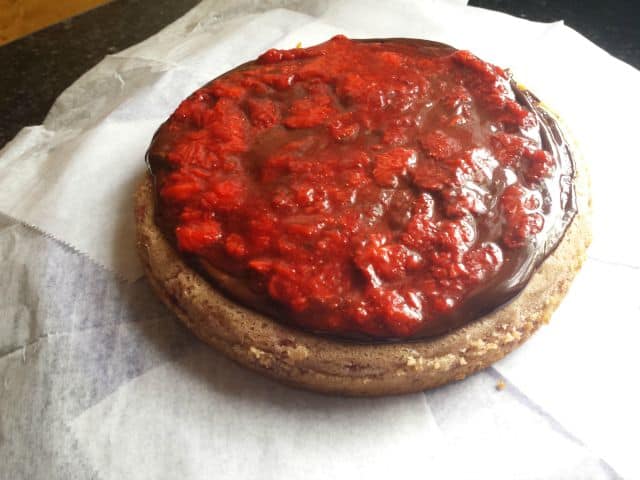 Add strawberries to homemade strawberry cake layer
