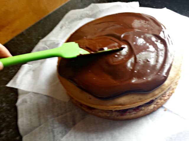 Spread ganache over the top layer of cake