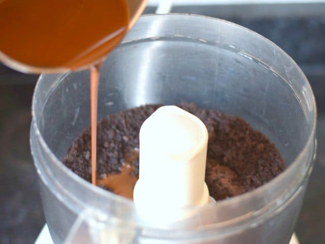 Add liquid magic shell to crumbled chocolate cookies