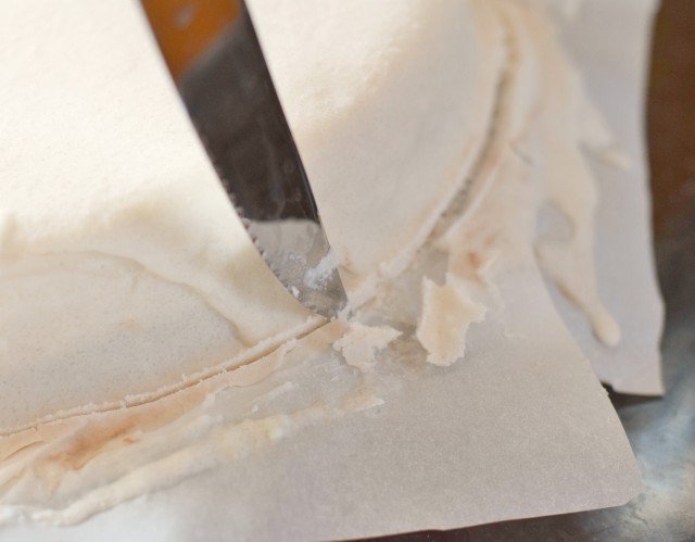 Use a knife to cut away excess frosting