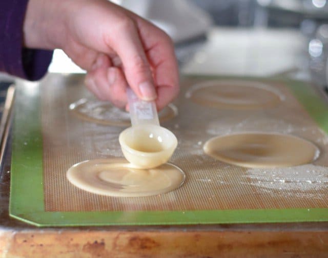 Add four homemade fortune cookies to your baking sheet at a time