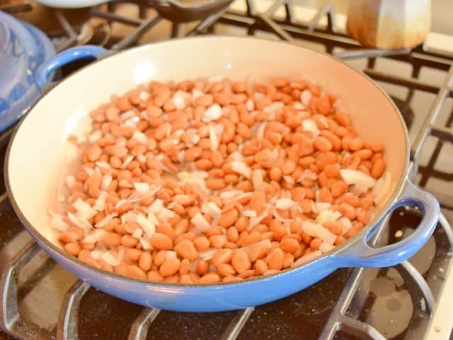 Cook up beans and onions for refried beans