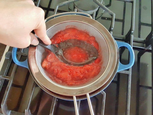Press strawberries through a steel mesh strainer