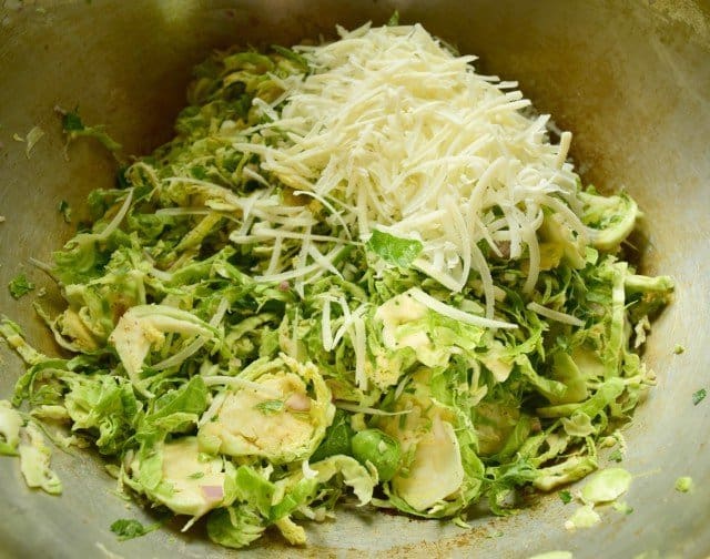 Add Parmesan cheese to shaved raw Brussels Sprout salad