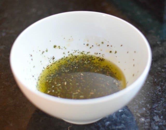 Add herbs and garlic to oil for Italian roasted veggies
