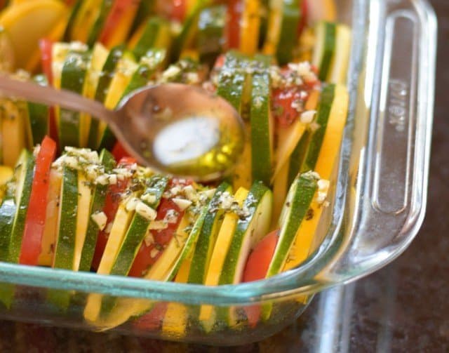 Drizzle olive oil and herbs over sliced veggies